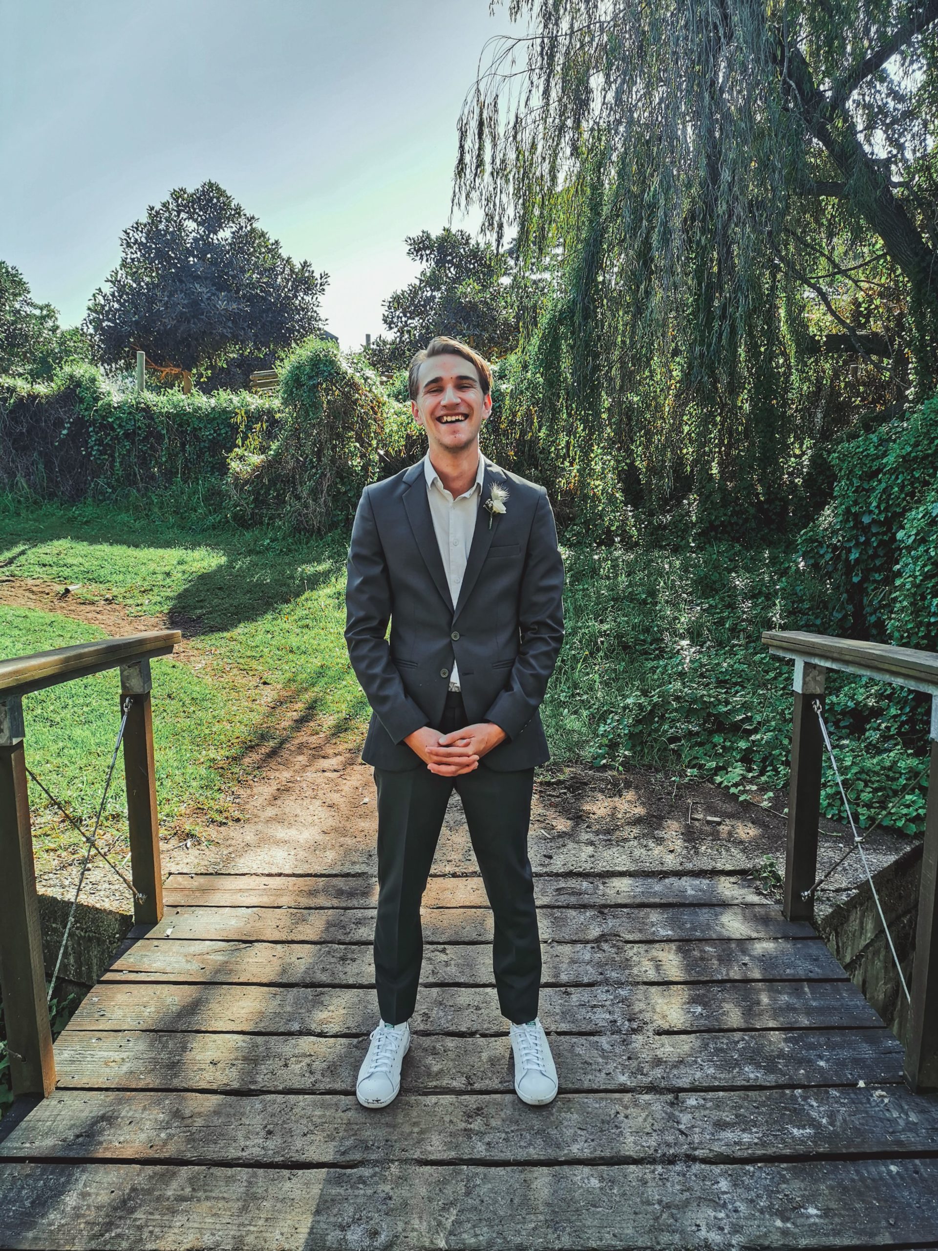 Tyrone Fisher, creator of Over Saturated, standing on a bridge